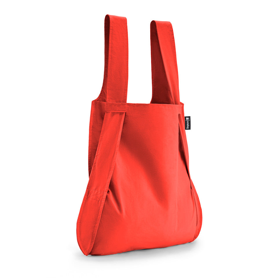 Not-a-bag re-usable fold-away pouch, red, shown as shopping bag.