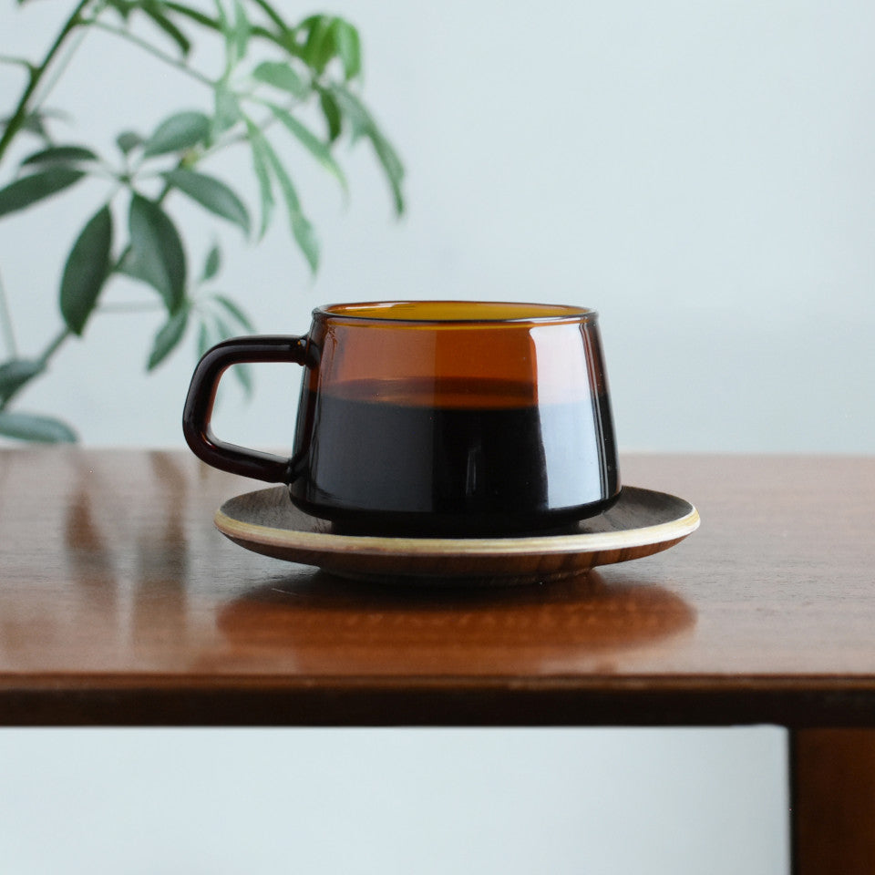Kinto Sepia glass teacup with teak saucer, styled.