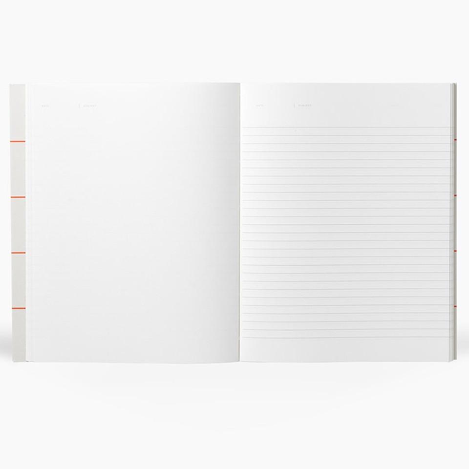 Uma light grey notebook, interior example with blank page on the left and ruled page on the right.