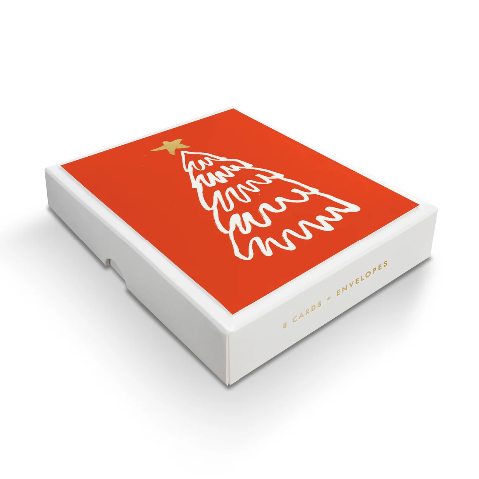 Box of Christmas cards with a red cover featuring a white tree design on a white background
