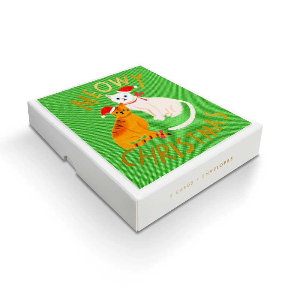 Box of Christmas cards with cartoon cats on a green background