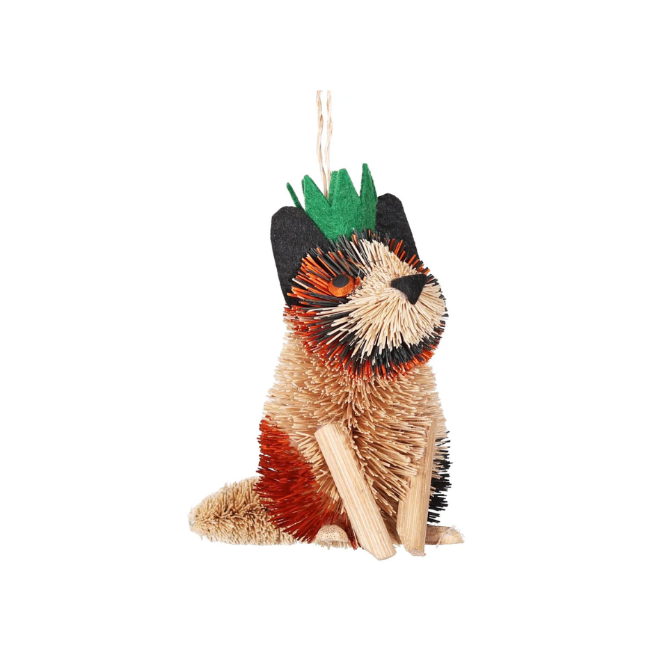 Decorative cat ornament with a green  crown on a white background
