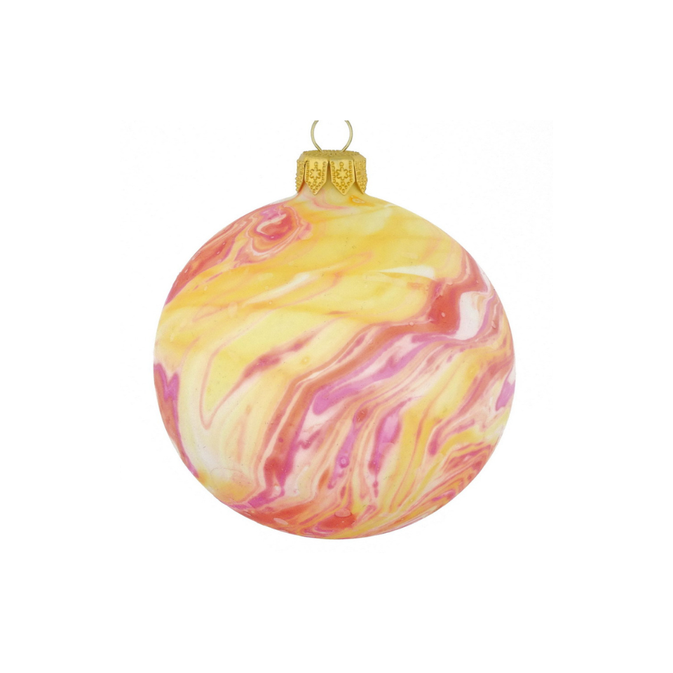 Marbled yellow and pink Christmas ornament on a white background