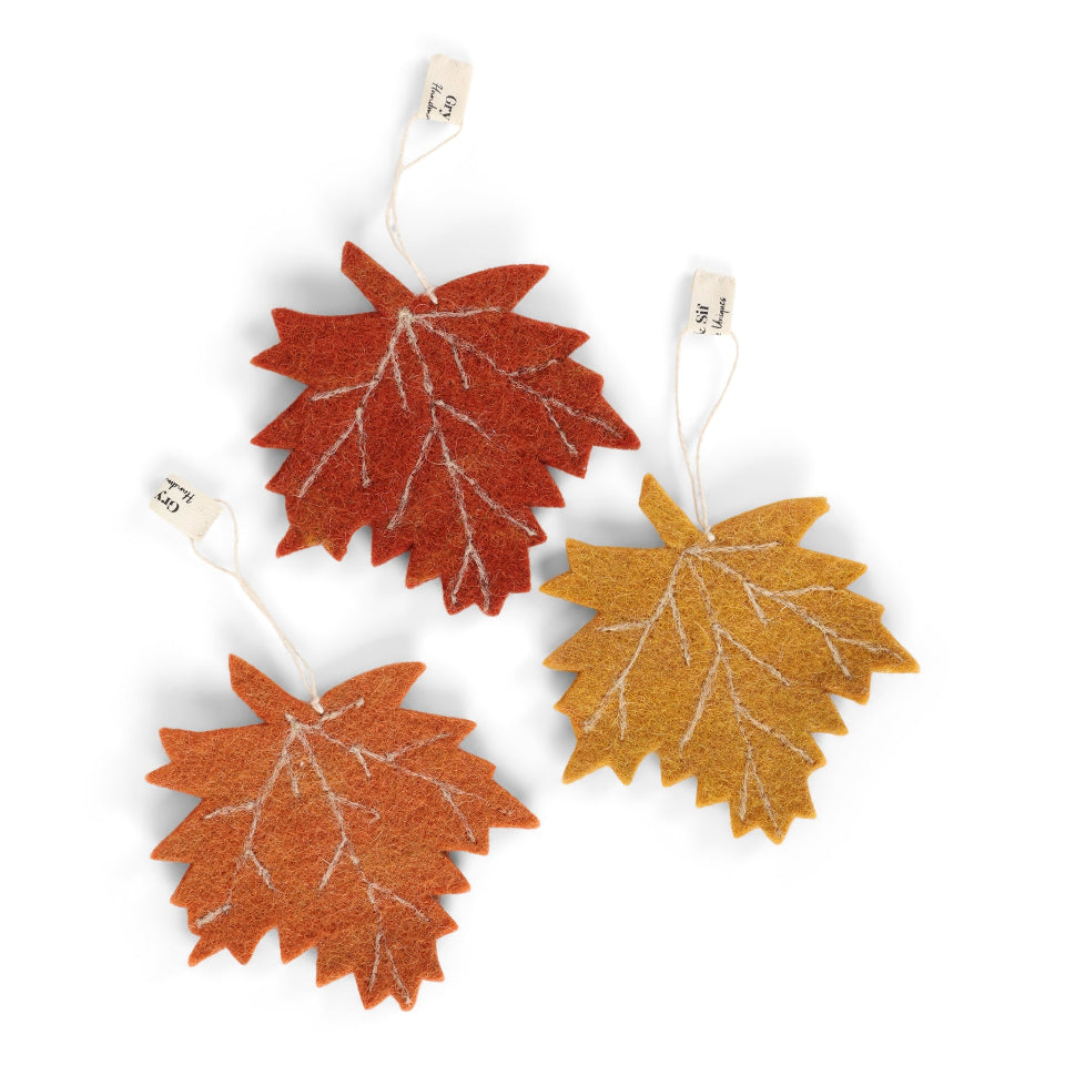 Three autumn-themed leaf decorations on white background