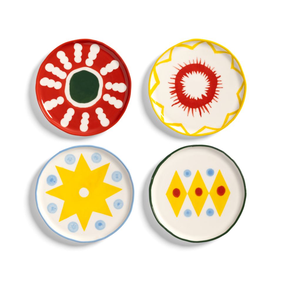 Four colorful ceramic plates with geometric patterns on a white background