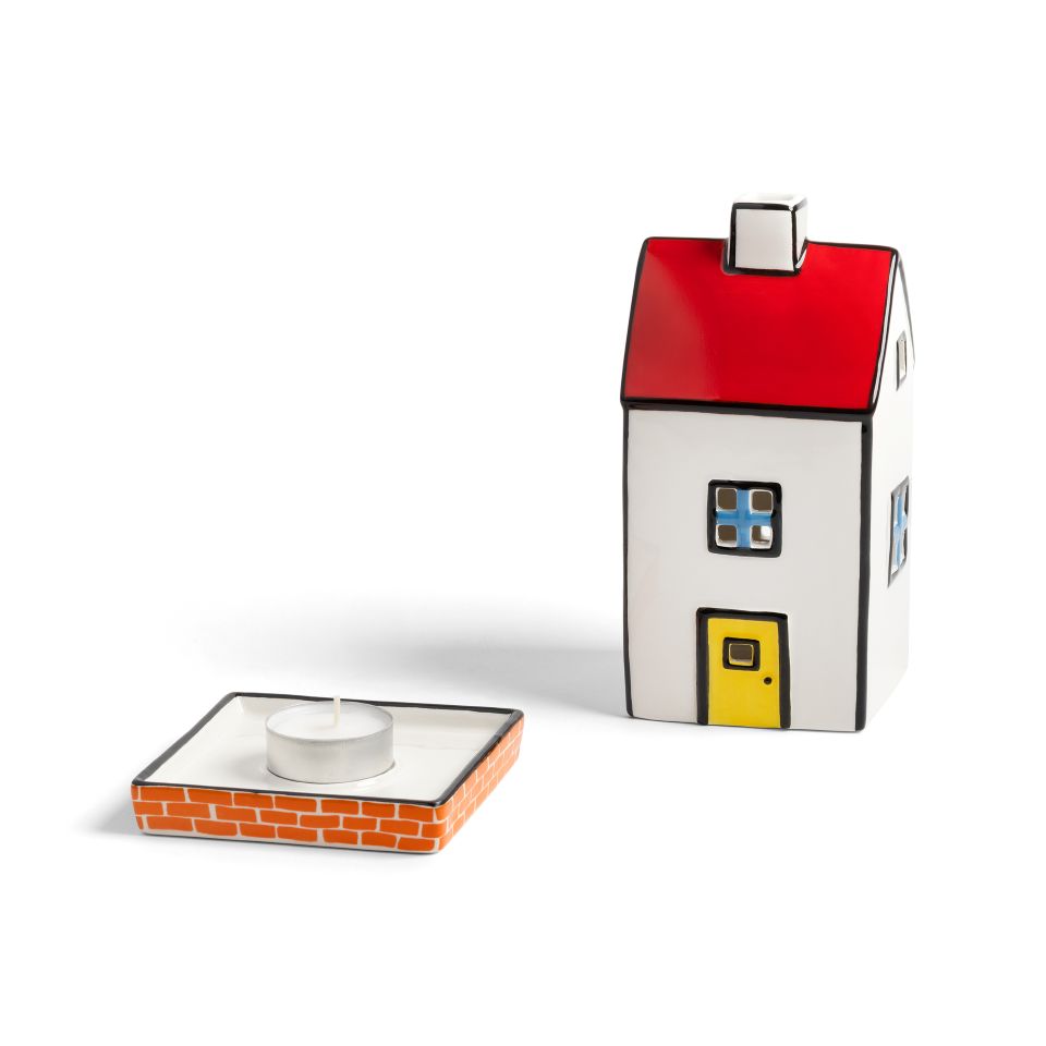 House-shaped candle holder with a red roof and yellow door on a white background