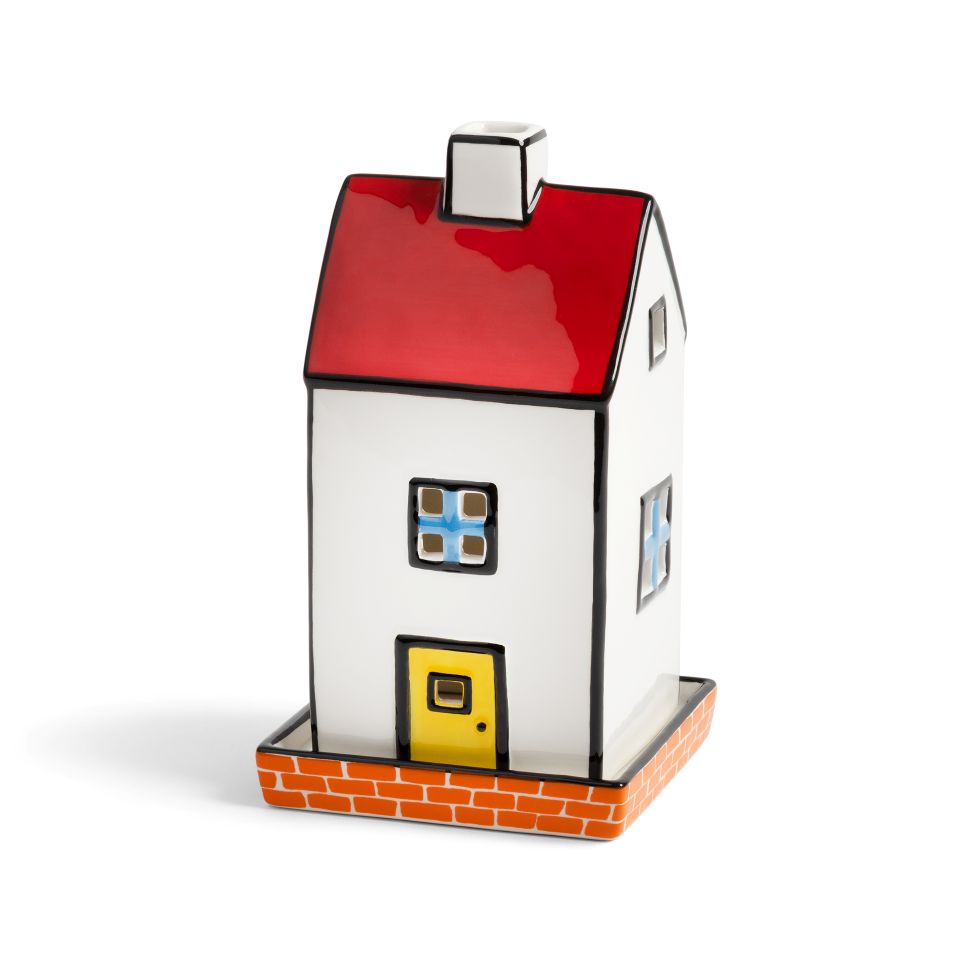House-shaped tea light holder with a red roof, white walls, and yellow door on a white background