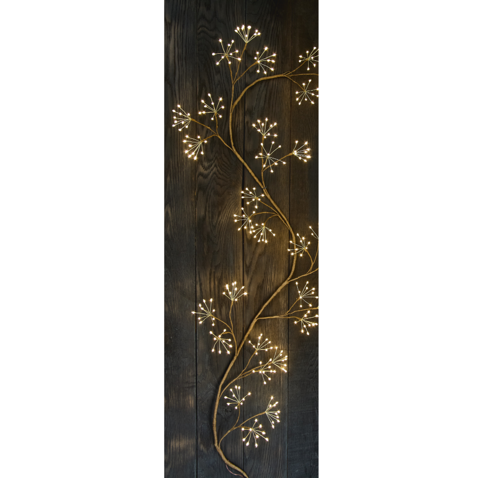 Decorative wall art with illuminated branches on a dark wooden panel
