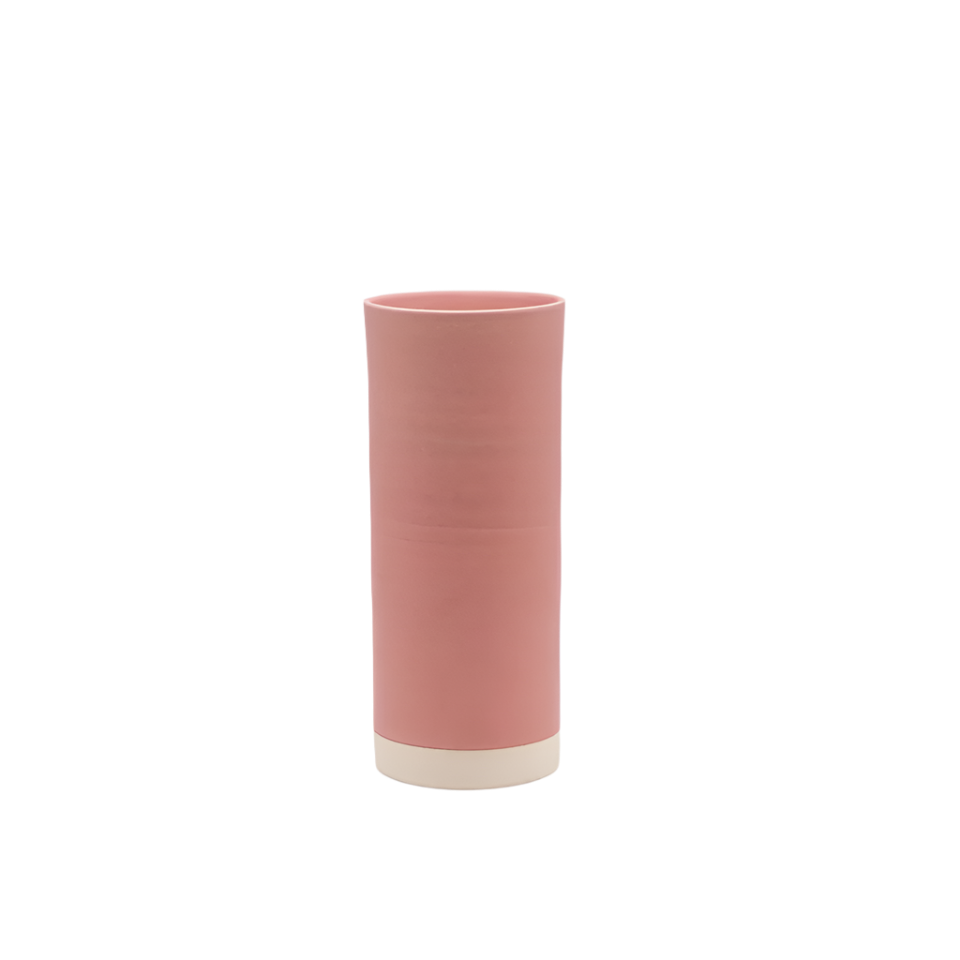 Pink cylindrical vase with a white base on a white background