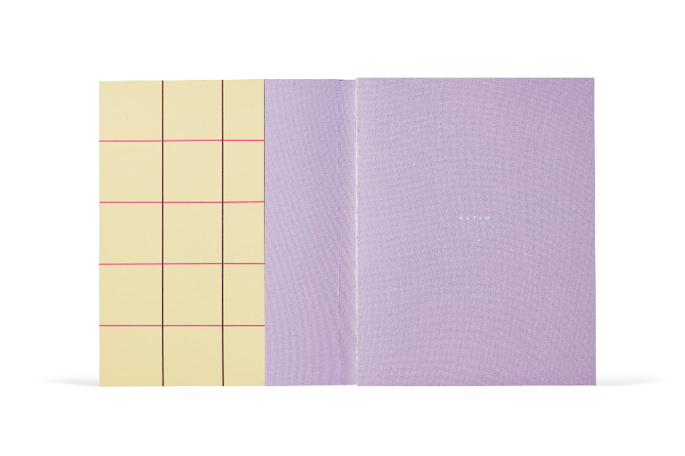 Open notebook with yellow grid and purple cover on a white background