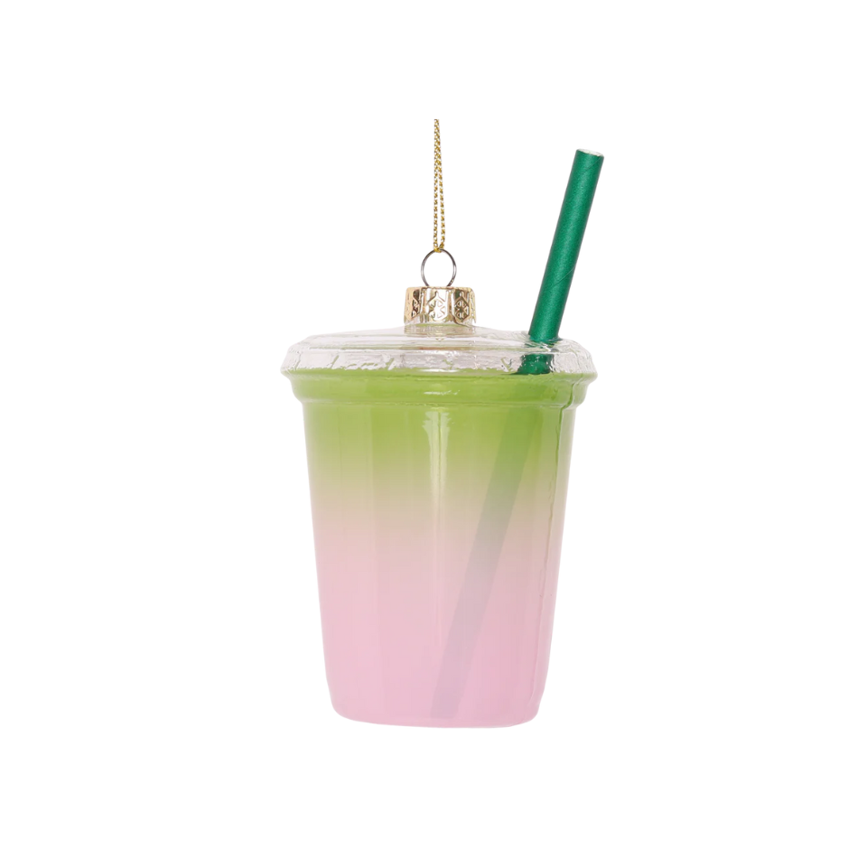 Gradient pink to green tumbler ornament with a straw on a white background