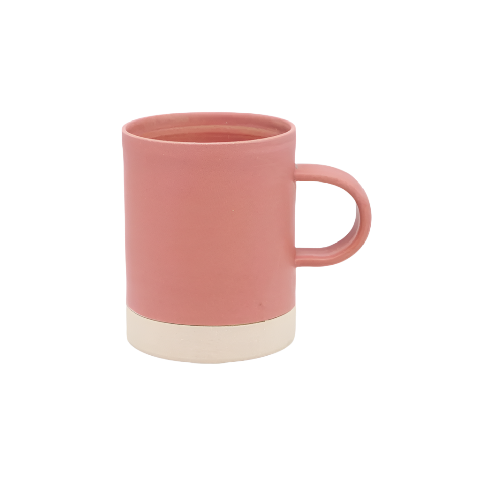 Pink ceramic mug with a beige base on a white background