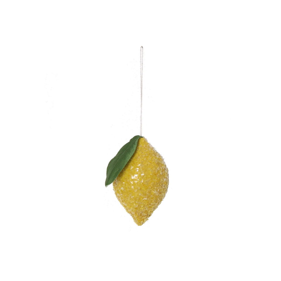 Decorative lemon ornament with a green leaf on a white background