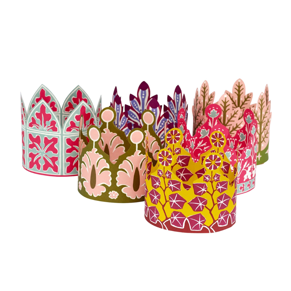 Set of colorful paper crowns with floral patterns on a white background