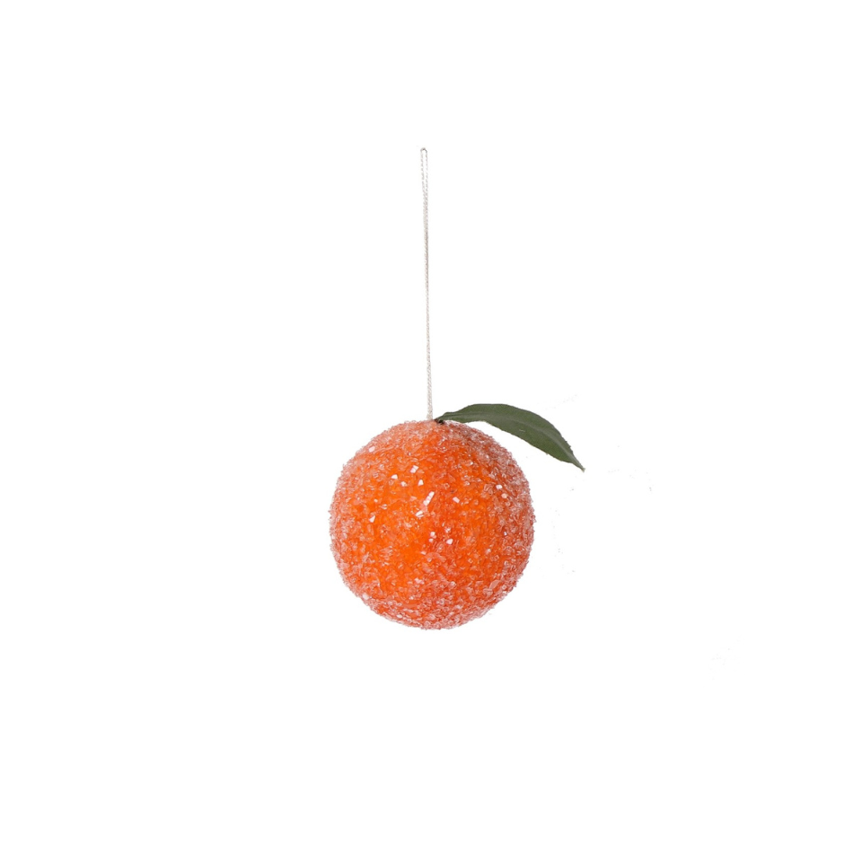 Decorative orange ornament with a green leaf on a white background
