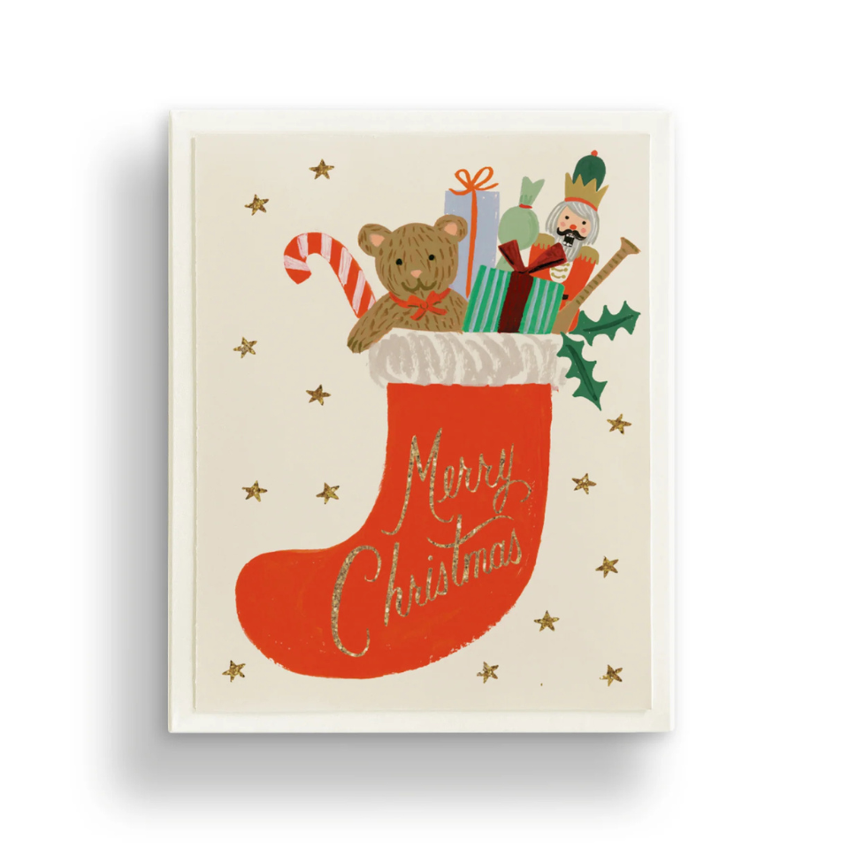 Christmas-themed illustration with a stocking, teddy bear, and Santa Claus on a beige background.