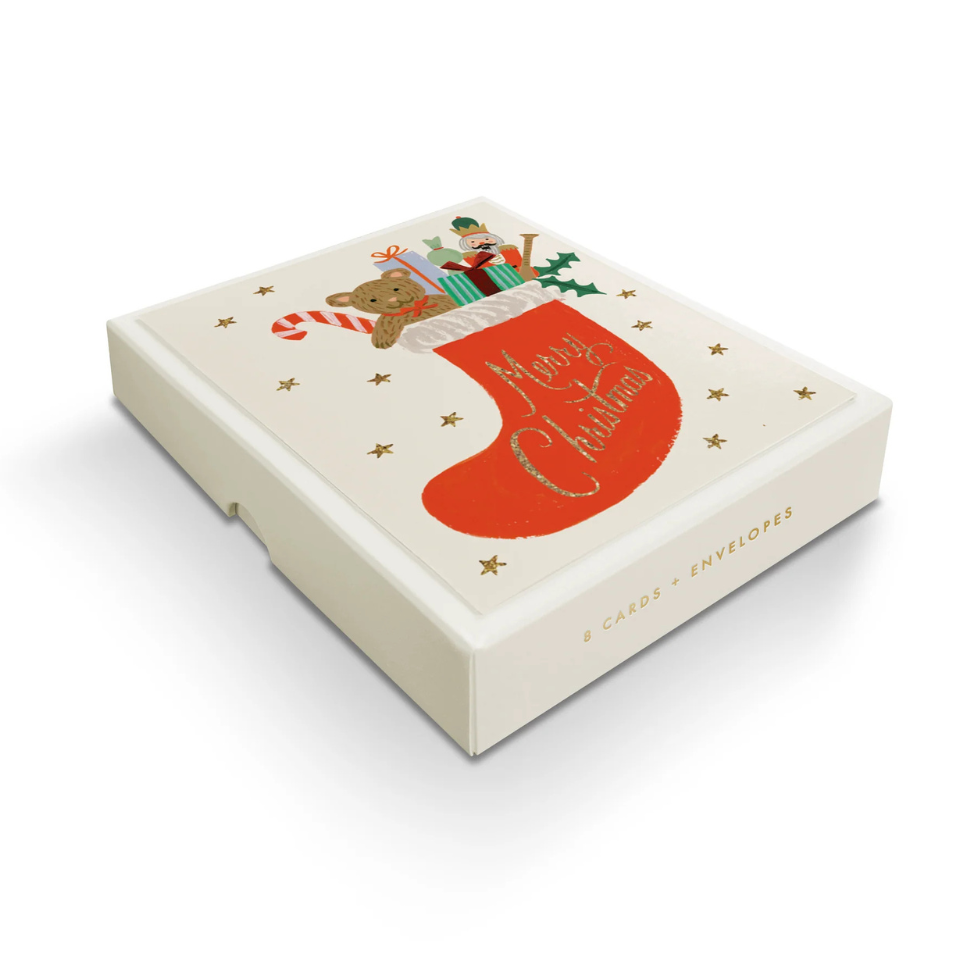 Box with Christmas design featuring a stocking and teddy bear on a white background