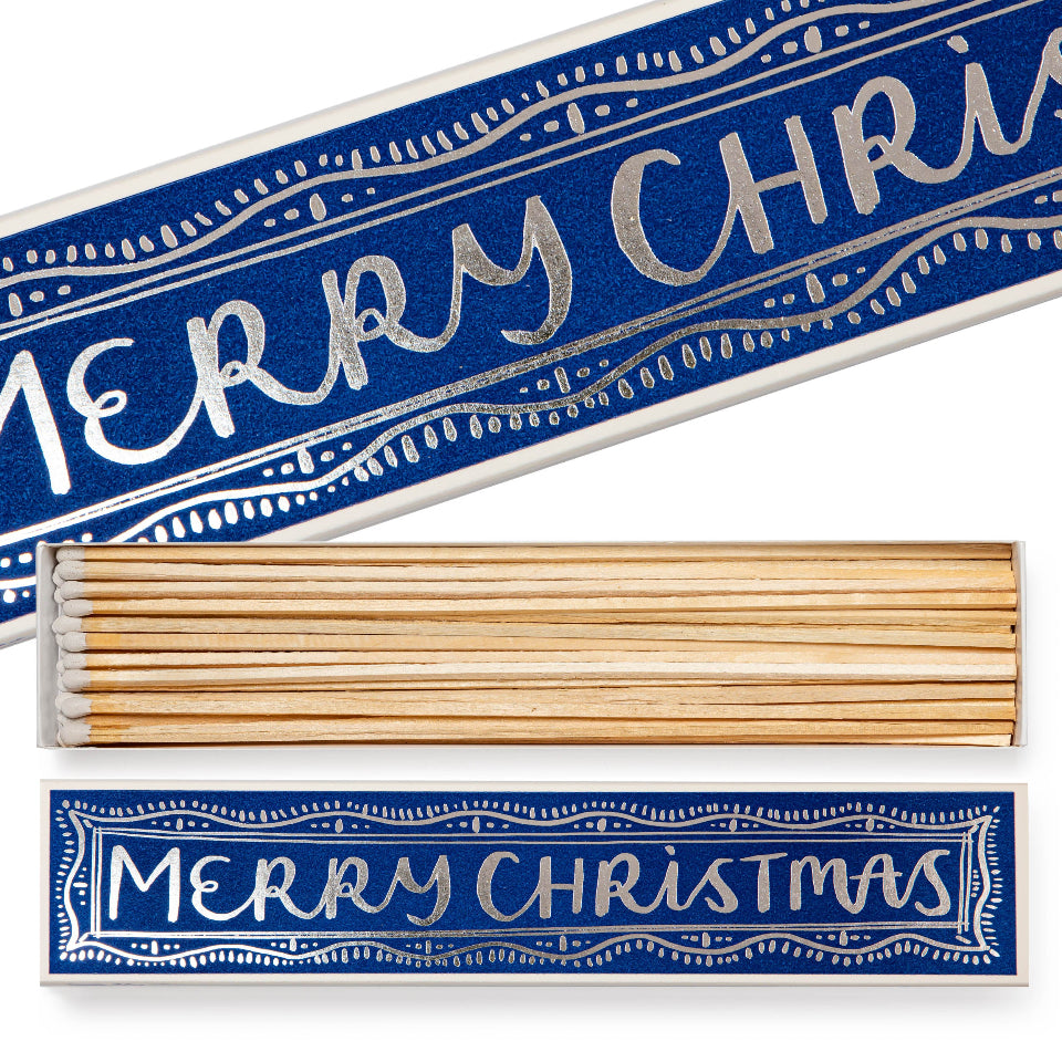 Box of match sticks with 'Merry Christmas' text on a blue background