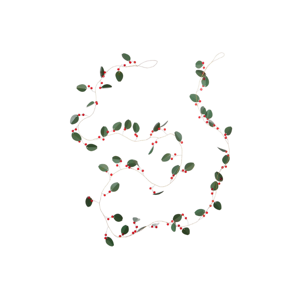 Decorative string with green leaves and red berries on a white background