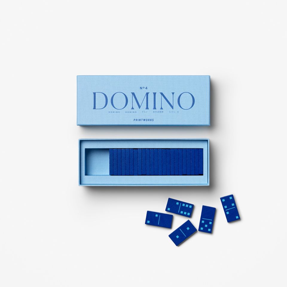 Blue domino set with packaging on a white background