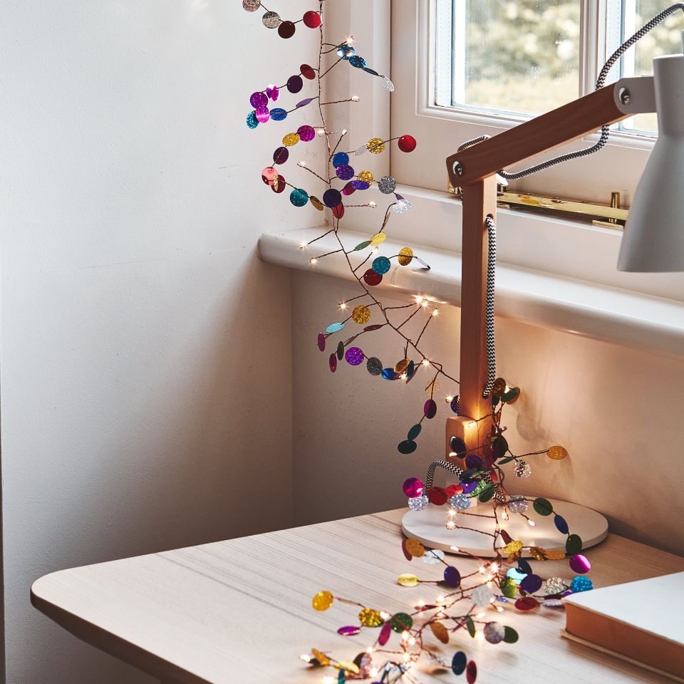 Light Chain with multi coloured discs  draped in a window 