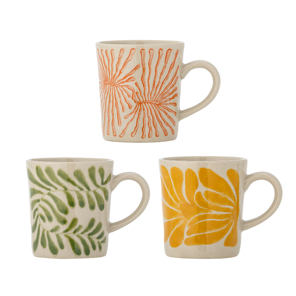 Three ceramic mugs with floral patterns on a white background