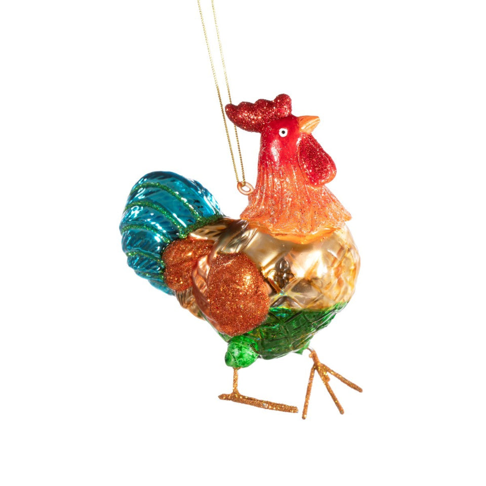 Colorful glass cockerel ornament on a white background