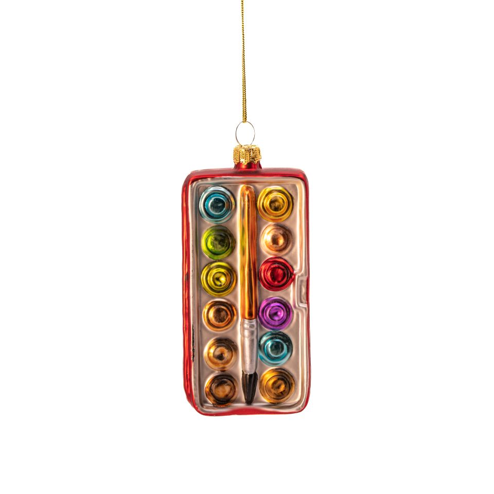 Decorative ornament shaped like a glass paint palette with colorful rings and a brush on a white background