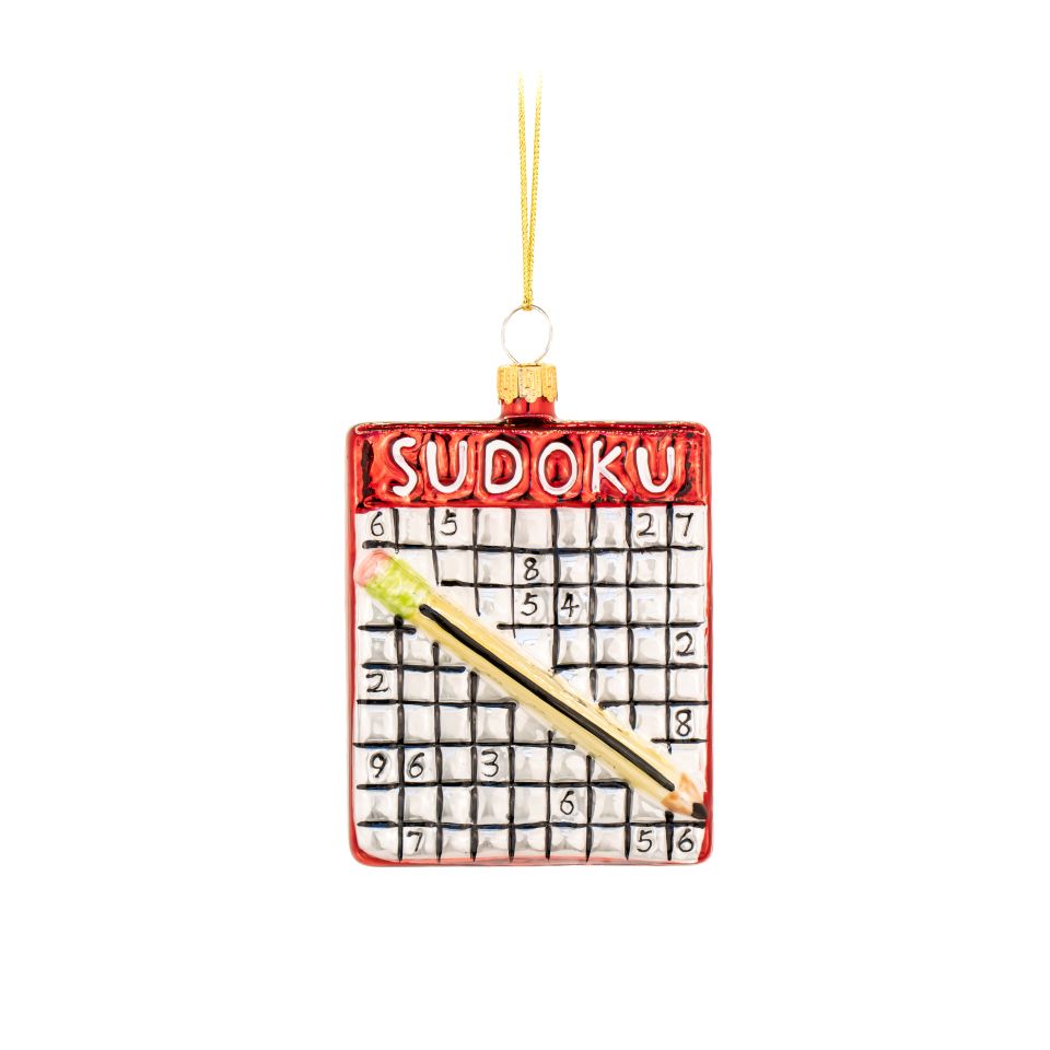 Sudoku puzzle ornament with a gold pencil on a white background