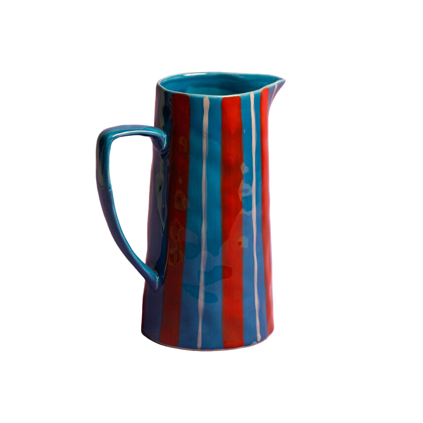 Ceramic pitcher with blue and red stripes on a white background