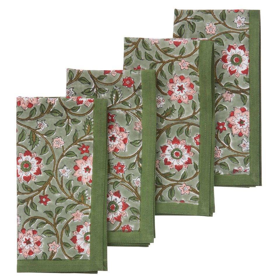 Set of four floral patterned napkins on a white background