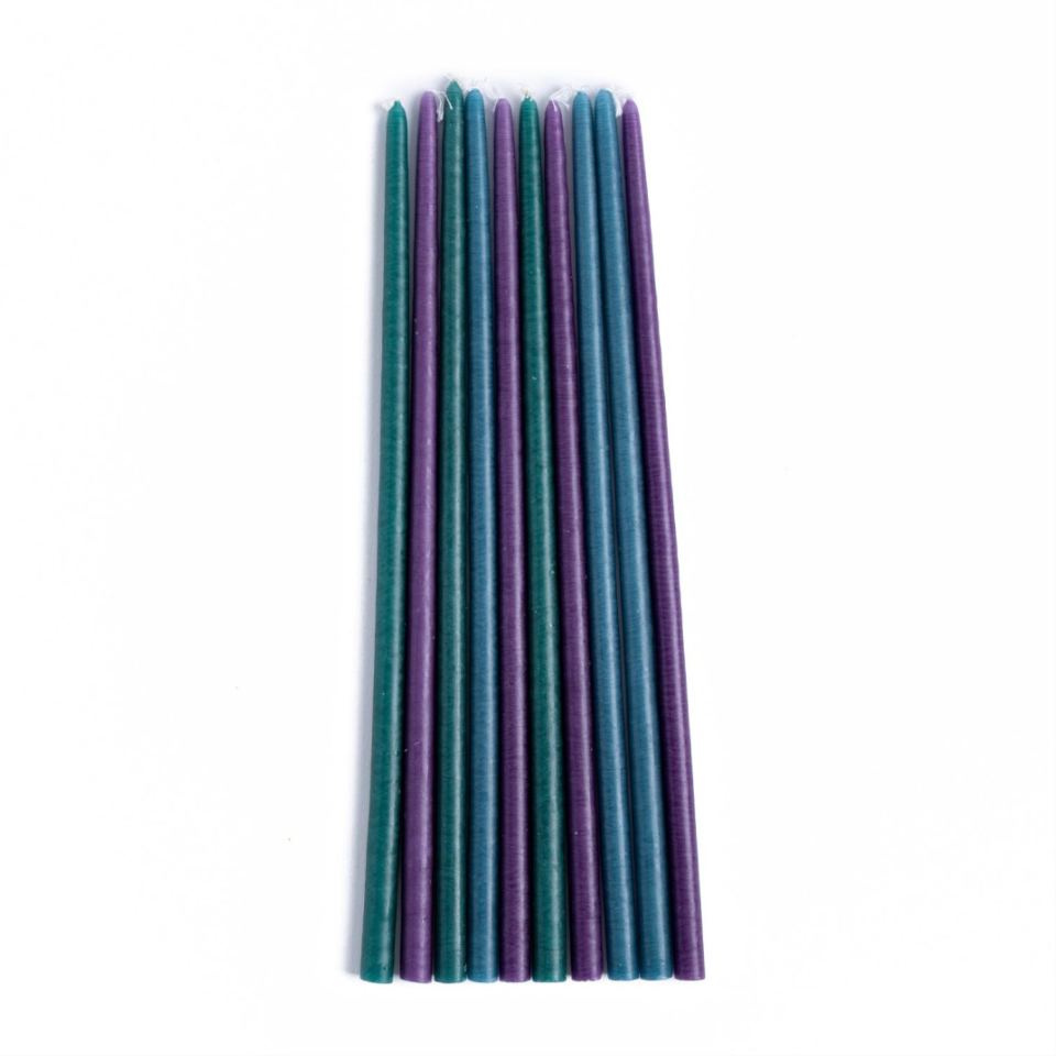 Set of teal and purple candles on a white background