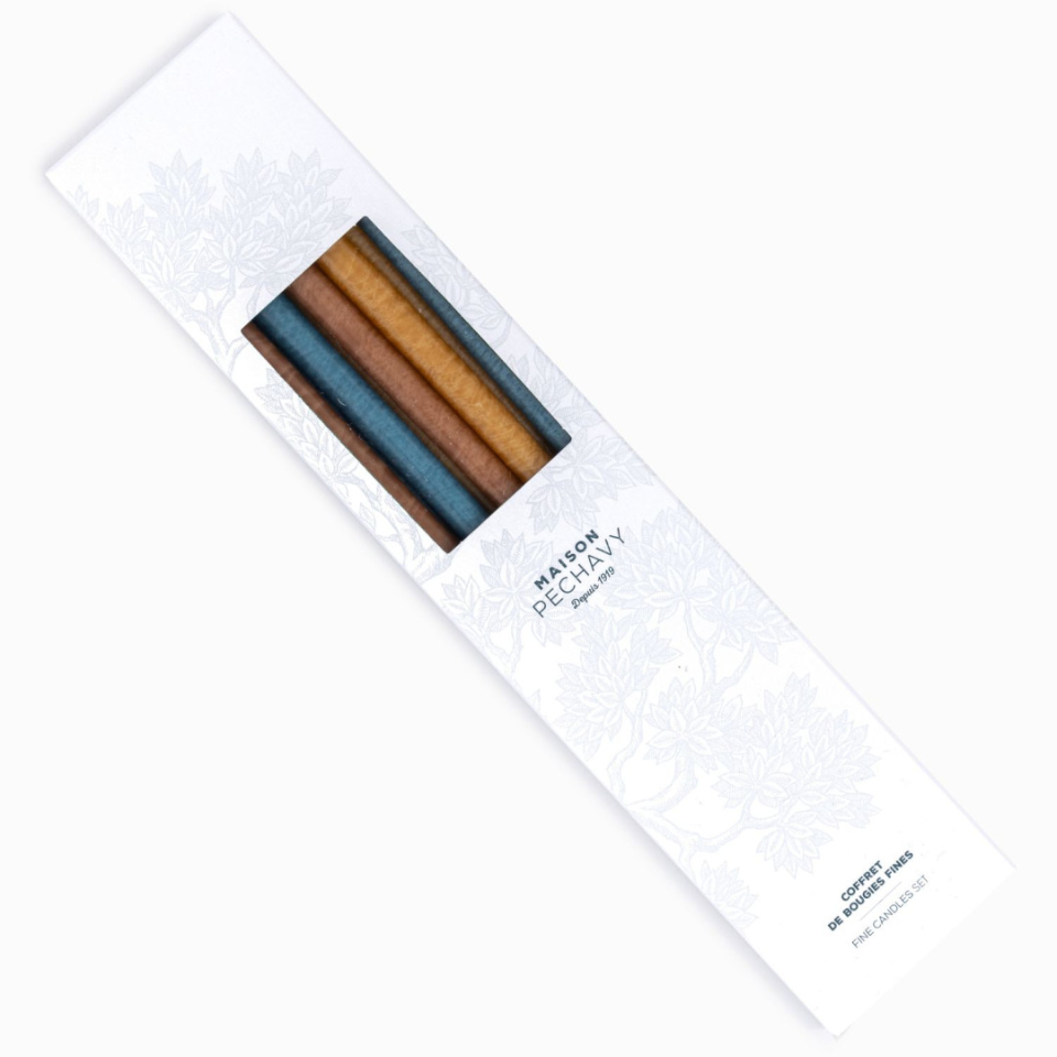 Box of fine taper candles in browns, blues and greens in a box.