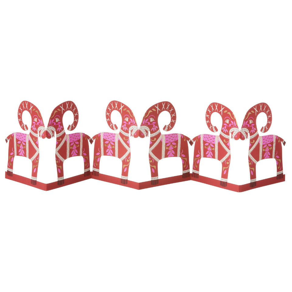 Decorative paper cutout of a goat with intricate patterns on a white background