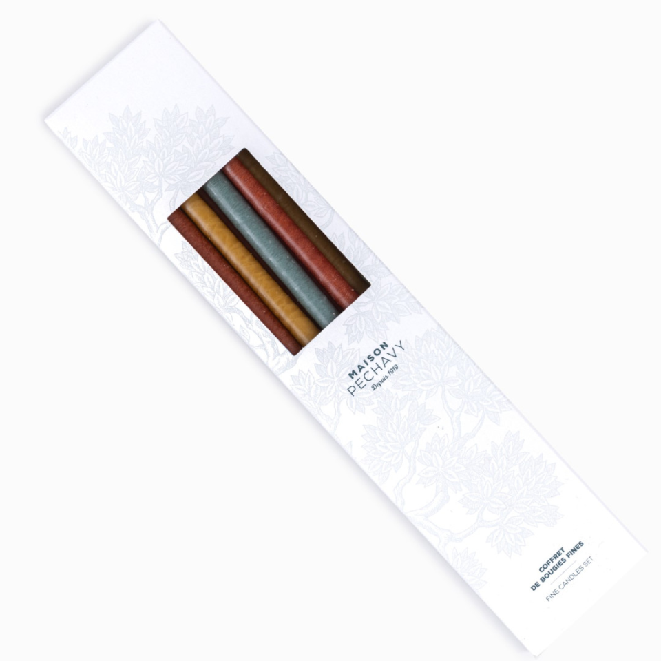 Box of fine taper candles in autumnal shades of rust, brown and blue 