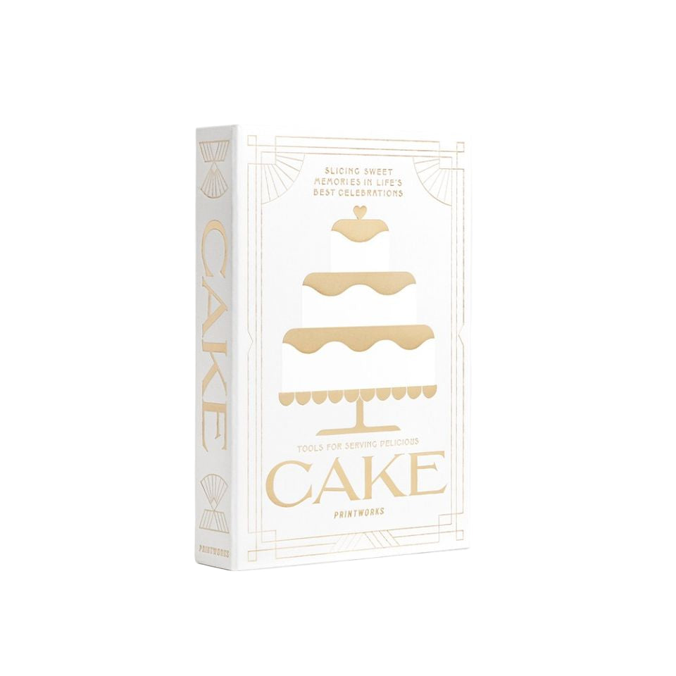 Storage box in the form of a book titled 'CAKE' with gold text on a white background
