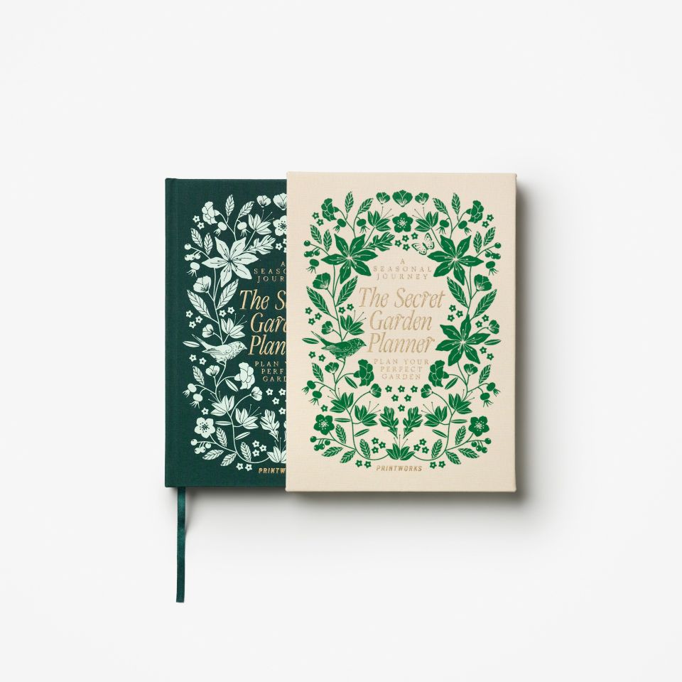 Book in a slip cover with green floral designs on a white background