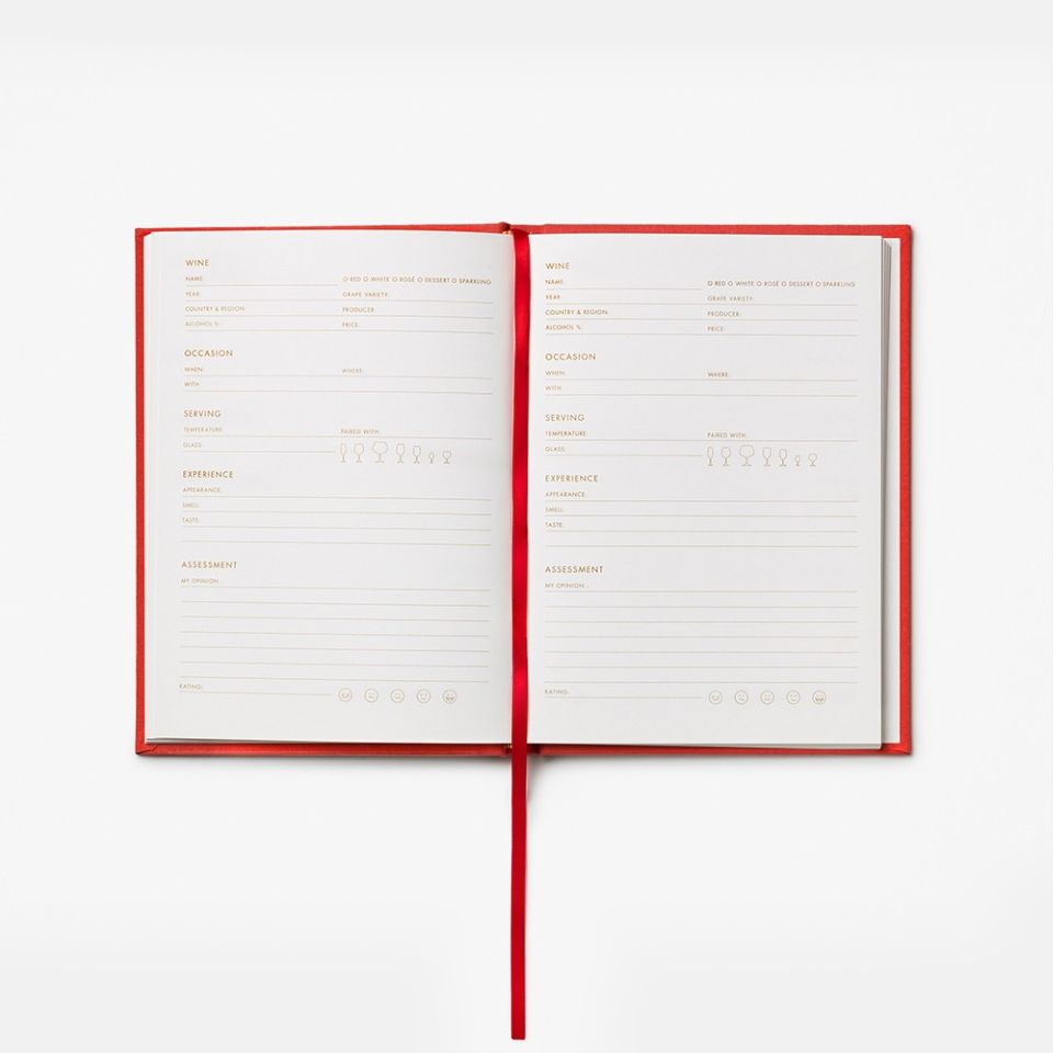 Open book with red binding on a white background