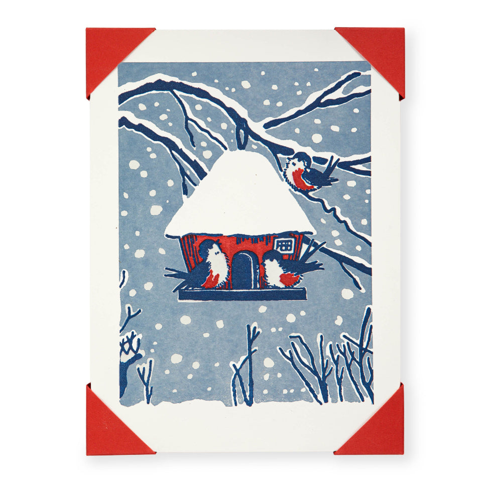 Card with a snowy scene featuring a birdhouse and birds.
