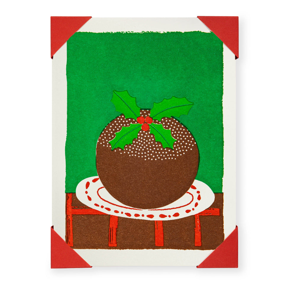 Christmas card with a brown Christmas pudding on a green background