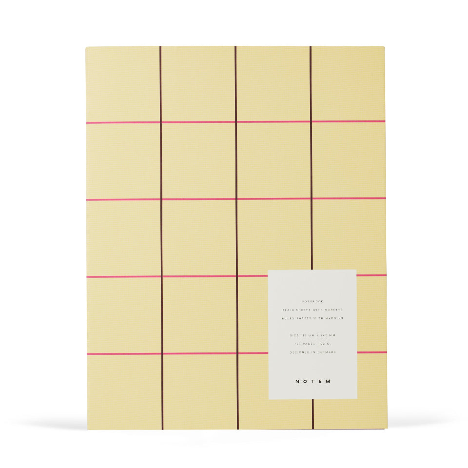 Yellow notebook with red lines and a white label on a white background
