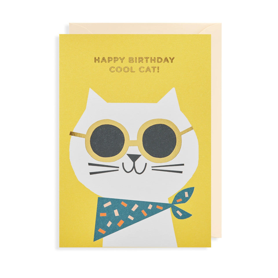 Happy Birthday Cool Cat!, blank birthday card, gold lettering on a yellow background above a grinning cat wearing gold-framed sunglasses and a bandana, with cream envelope.