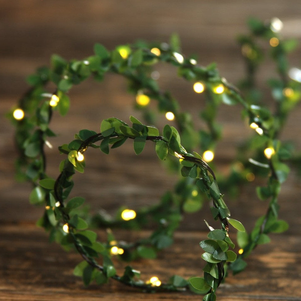 Greenery light chain - battery operated, on a wooden table.