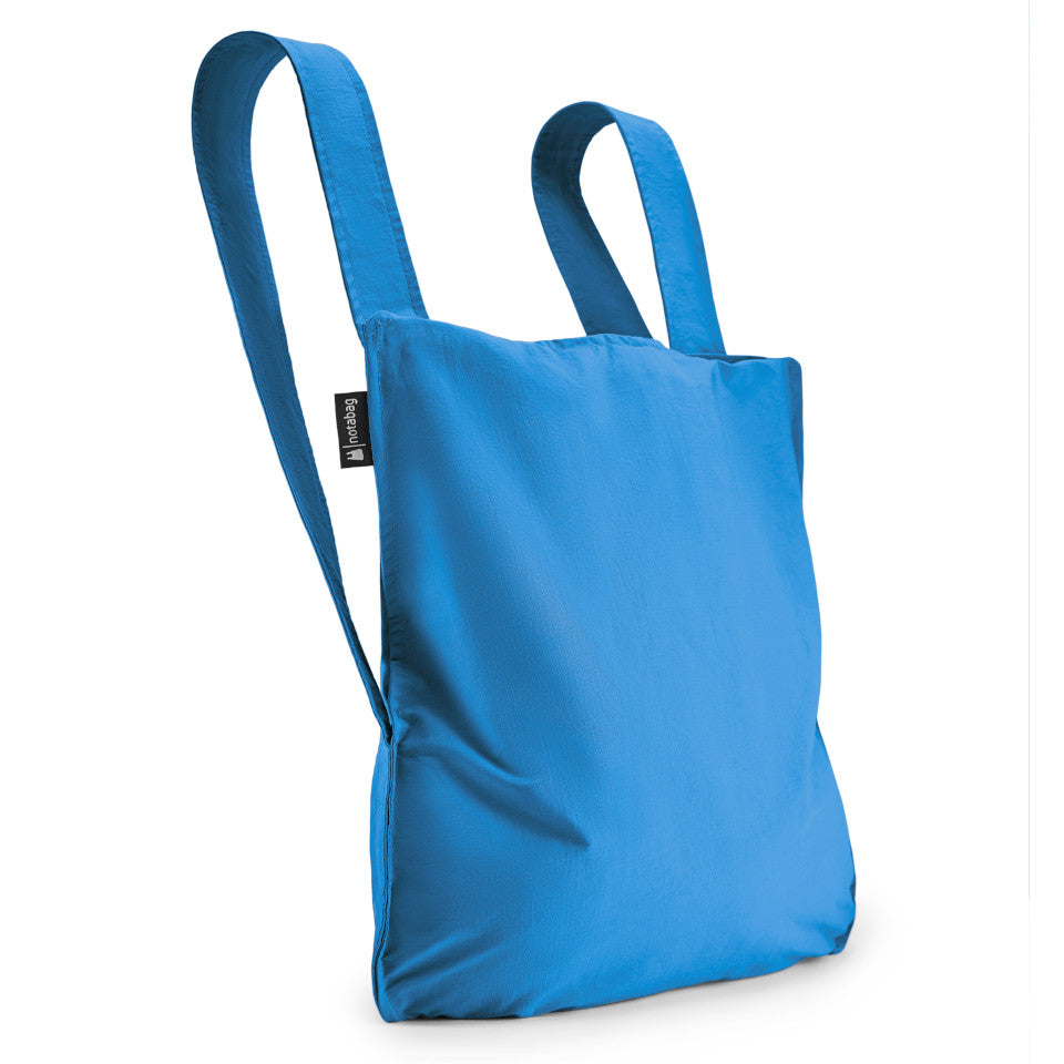 Not-a-bag re-usable fold-away pouch, blue, shown as backpack.