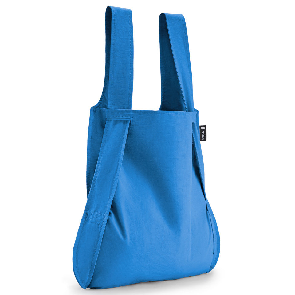 Not-a-bag re-usable fold-away pouch, blue, shown as shopping bag.