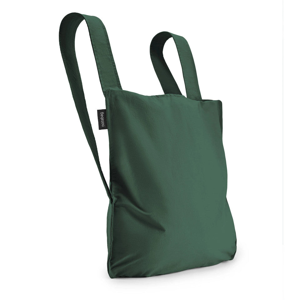 Not-a-bag re-usable fold-away pouch, forest green, shown as backpack.