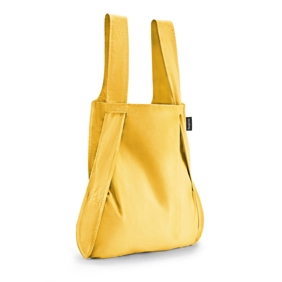 Not-a-bag re-usable fold-away pouch, golden, shown as shopping bag.