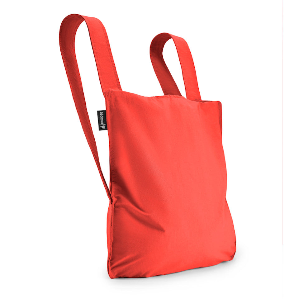 Not-a-bag re-usable fold-away pouch, red, shown as backpack.