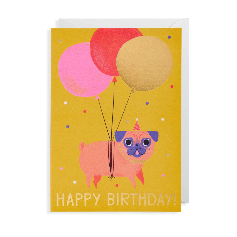 Happy Birthday!, blank birthday card, gold lettering under pink, red and yellow balloons tied around a plump pugs, (wearing a party hat) midriff, with white envelope.