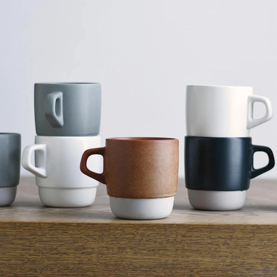 SCS stacking mugs, stacked and styled on a sideboard.